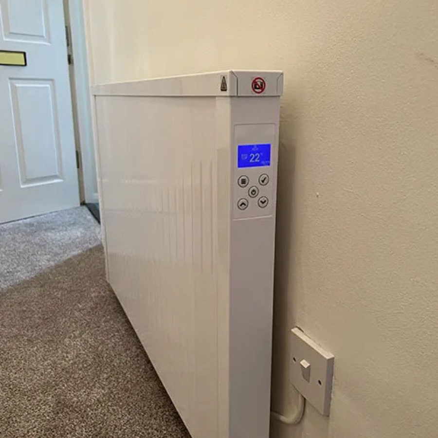 A NEOS electric radiator fitted in a hallway